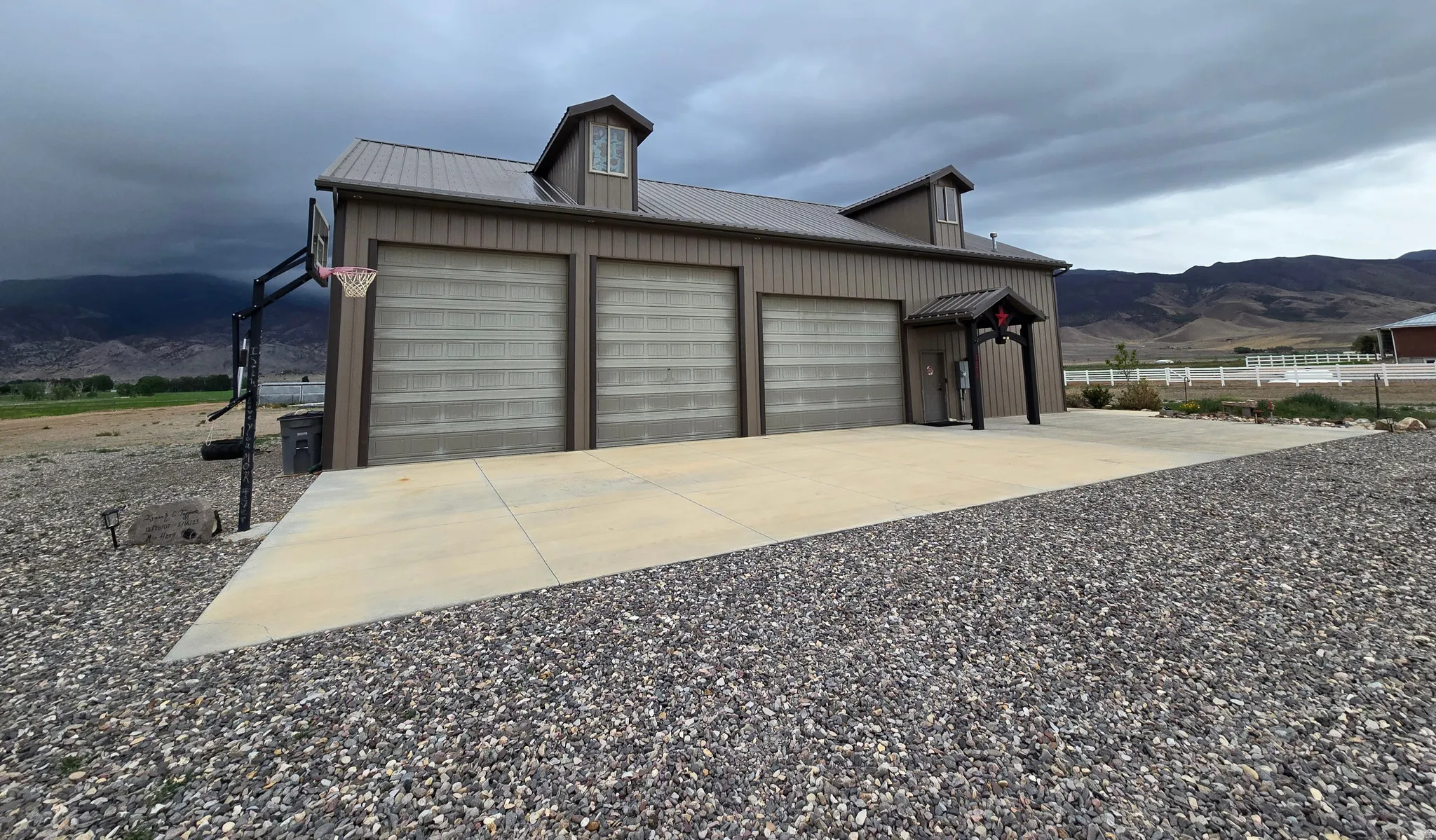 Three bay garage building with metal siding and a standing seam metal roof
