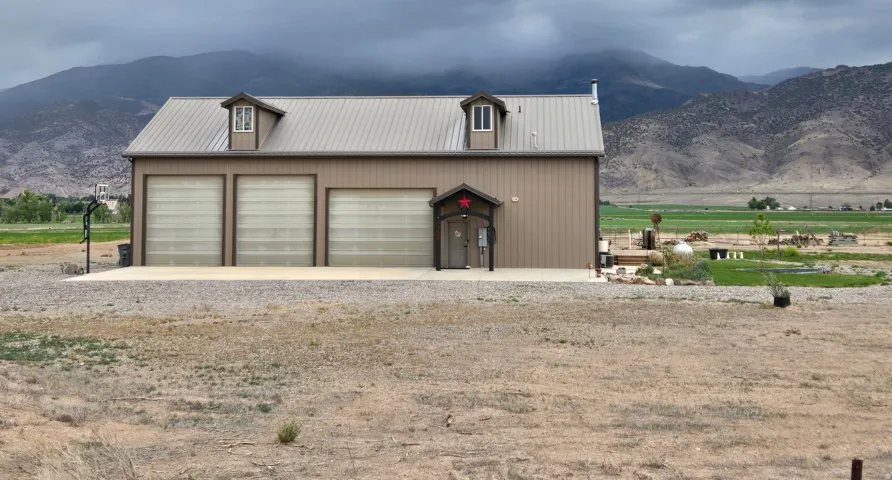 Three-bay garage with dormer windows and a metal roof
