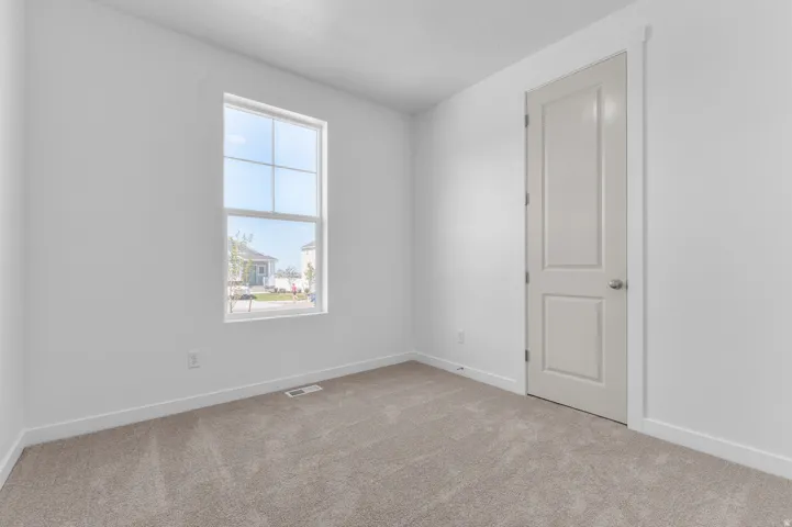 Neutral-toned carpeting paired with crisp white walls and baseboards