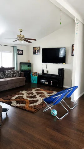 Living area featuring wood-finish flooring, a vaulted ceiling, and recessed lighting