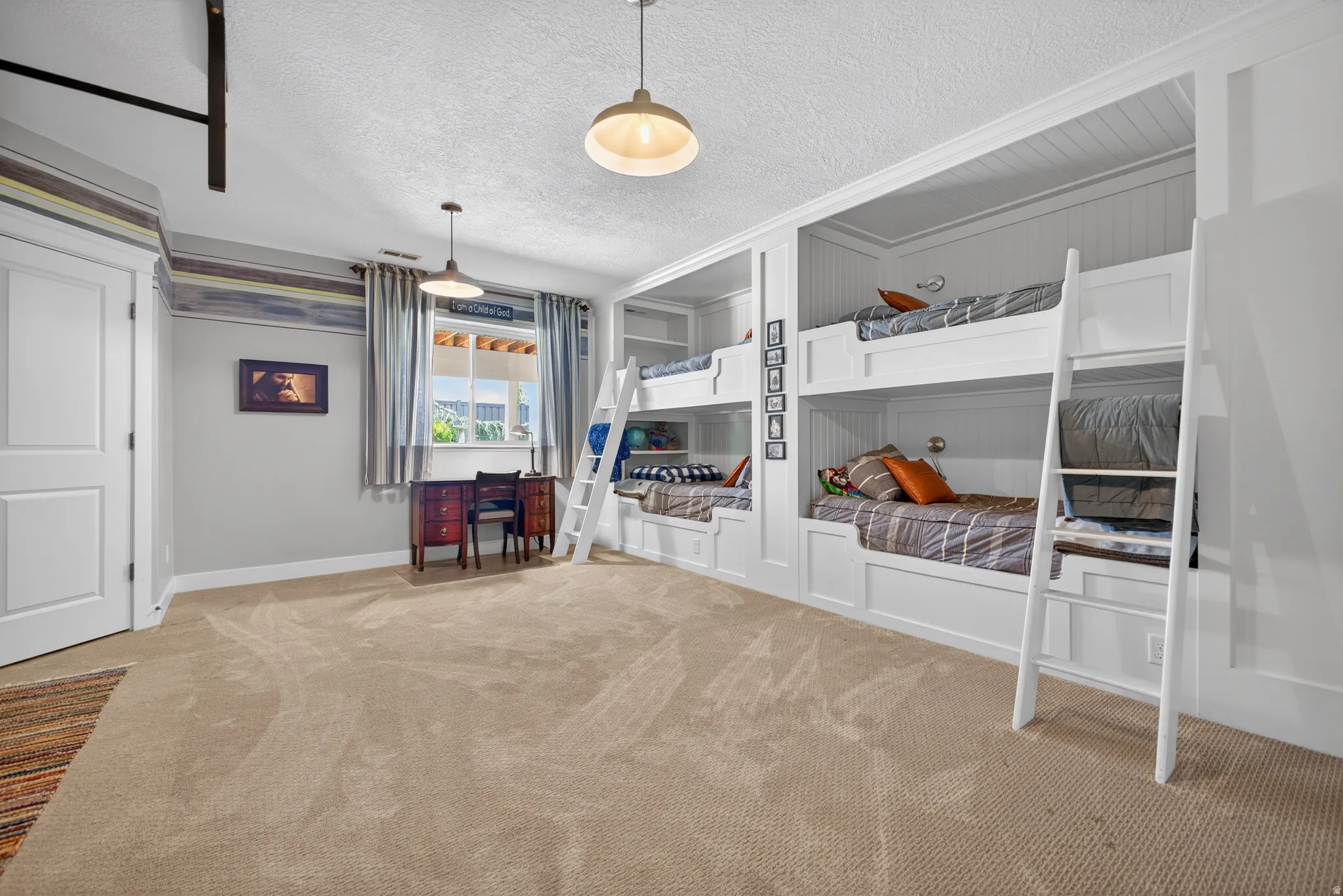 Built-in bunk beds with integrated shelving and wall sconces