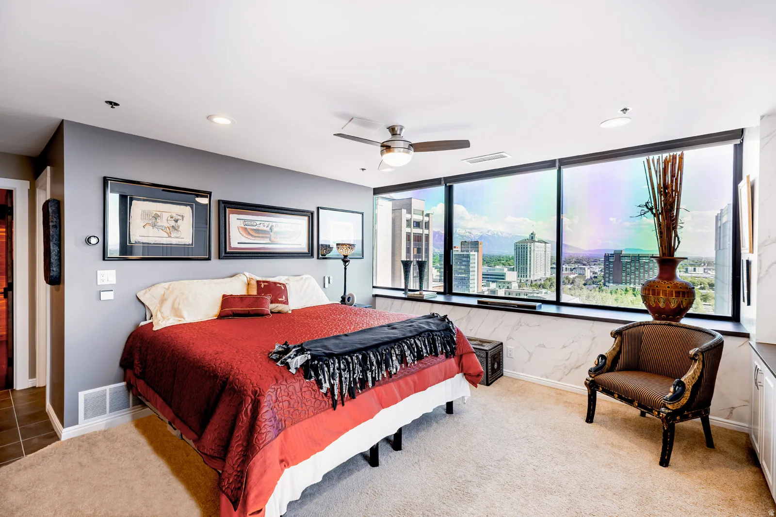 Spacious room featuring floor-to-ceiling windows, recessed lighting, and a ceiling fan