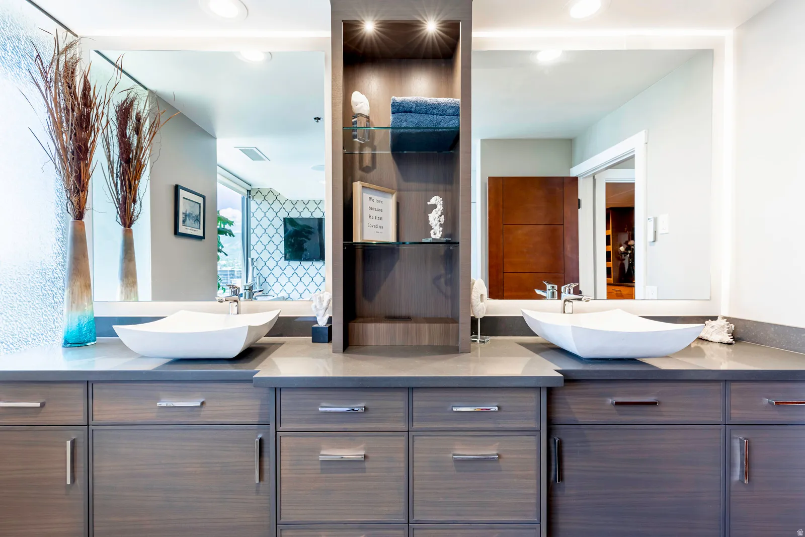 Dual vanity with wood-finish cabinetry, under-mount lighting, and integrated vessel sinks