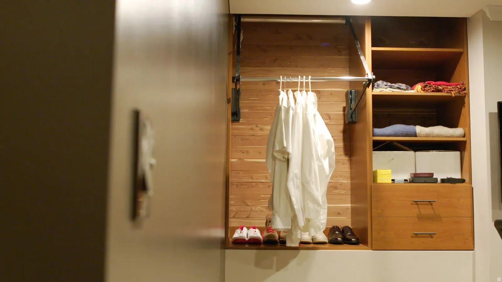 Custom closet system featuring natural wood-finish construction, integrated shelving, and two soft-close drawers