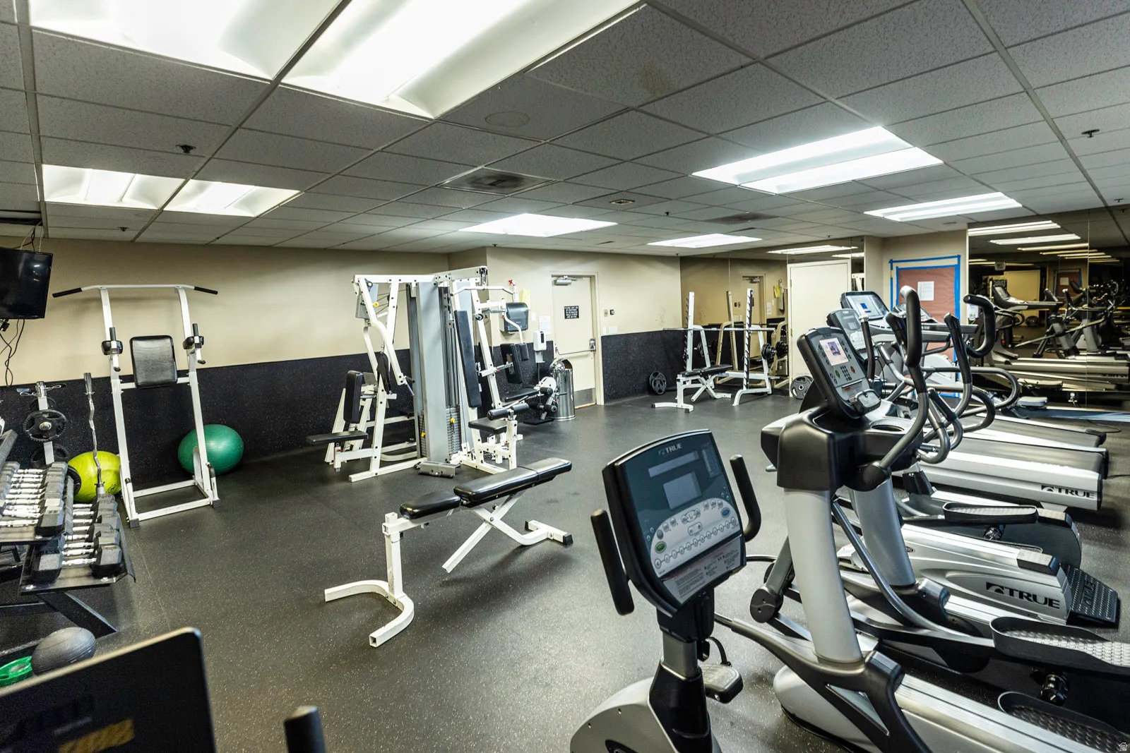 Fitness center featuring dedicated cardio and weight training zones