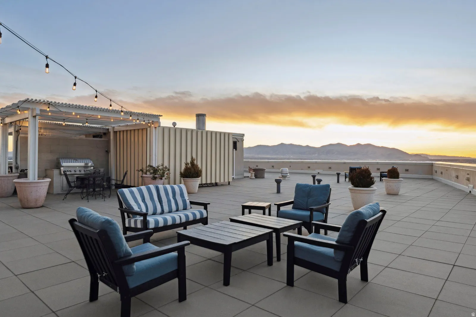Expansive rooftop deck featuring large format tile flooring and a mountain backdrop