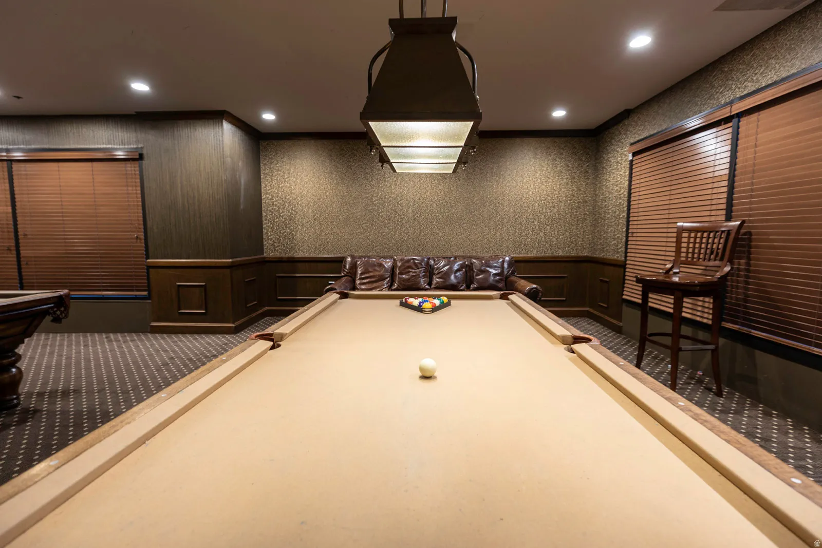 Recreation room featuring a billiards table with a distinctive overhead light fixture