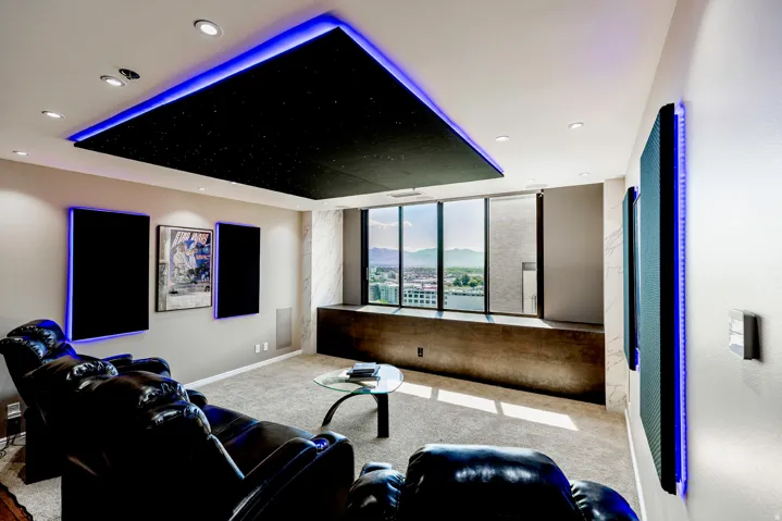 Media room featuring a recessed ceiling with perimeter lighting and integrated downlights