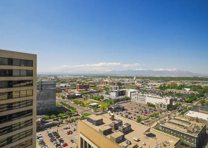 Expansive urban landscape featuring a clear skyline and distant snow-capped mountains