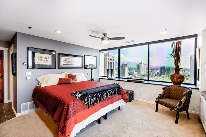 Spacious room featuring floor-to-ceiling windows, recessed lighting, and a ceiling fan