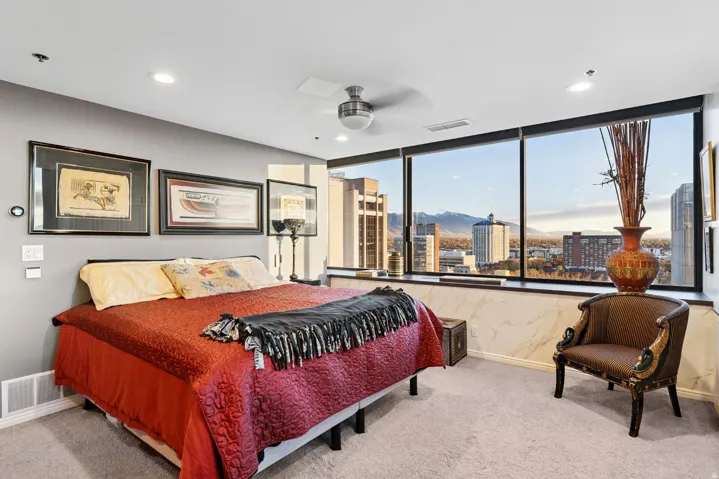 Expansive window wall offering city and mountain scenery