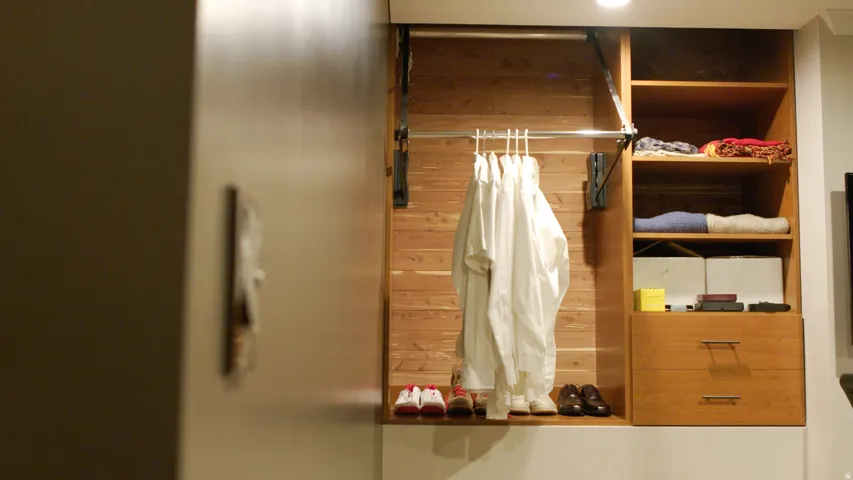 Custom closet system featuring natural wood-finish construction, integrated shelving, and two soft-close drawers