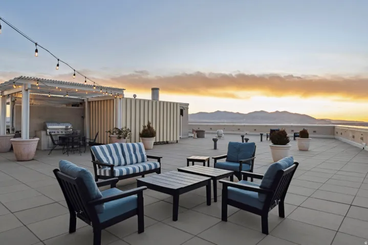 Expansive rooftop deck featuring large format tile flooring and a mountain backdrop