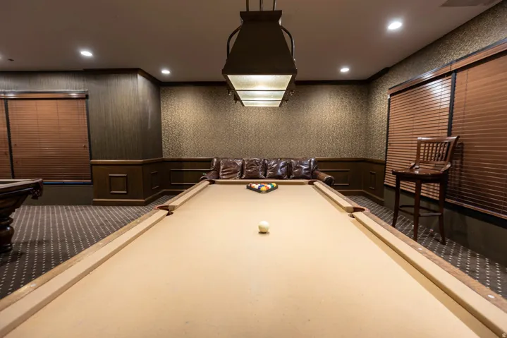 Recreation room featuring a billiards table with a distinctive overhead light fixture