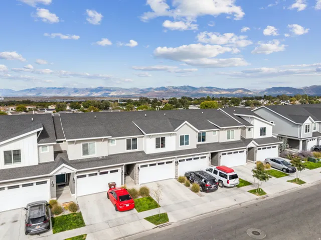 Contemporary townhome-style residences featuring attached garages and uniform landscaping