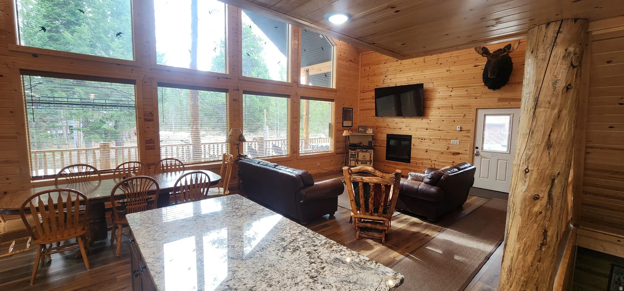 Spacious open-concept interior featuring prominent wood-finish walls and ceilings