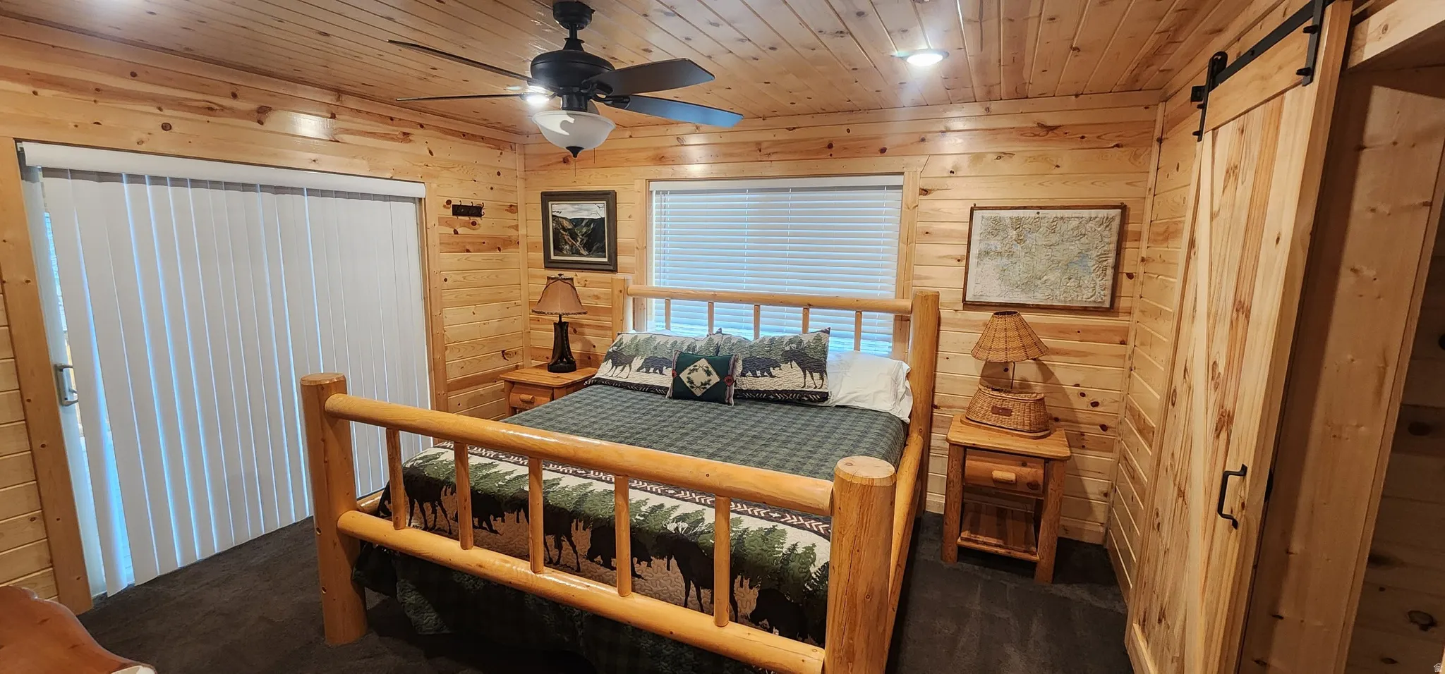 Wood-paneled interior featuring a ceiling fan with light fixture, recessed lighting, and a sliding door with vertical blinds