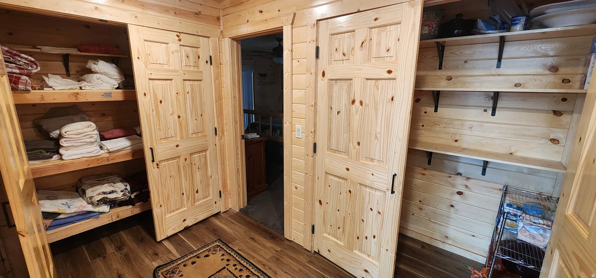 Wood-finish flooring throughout, complemented by wood paneling on walls and ceilings