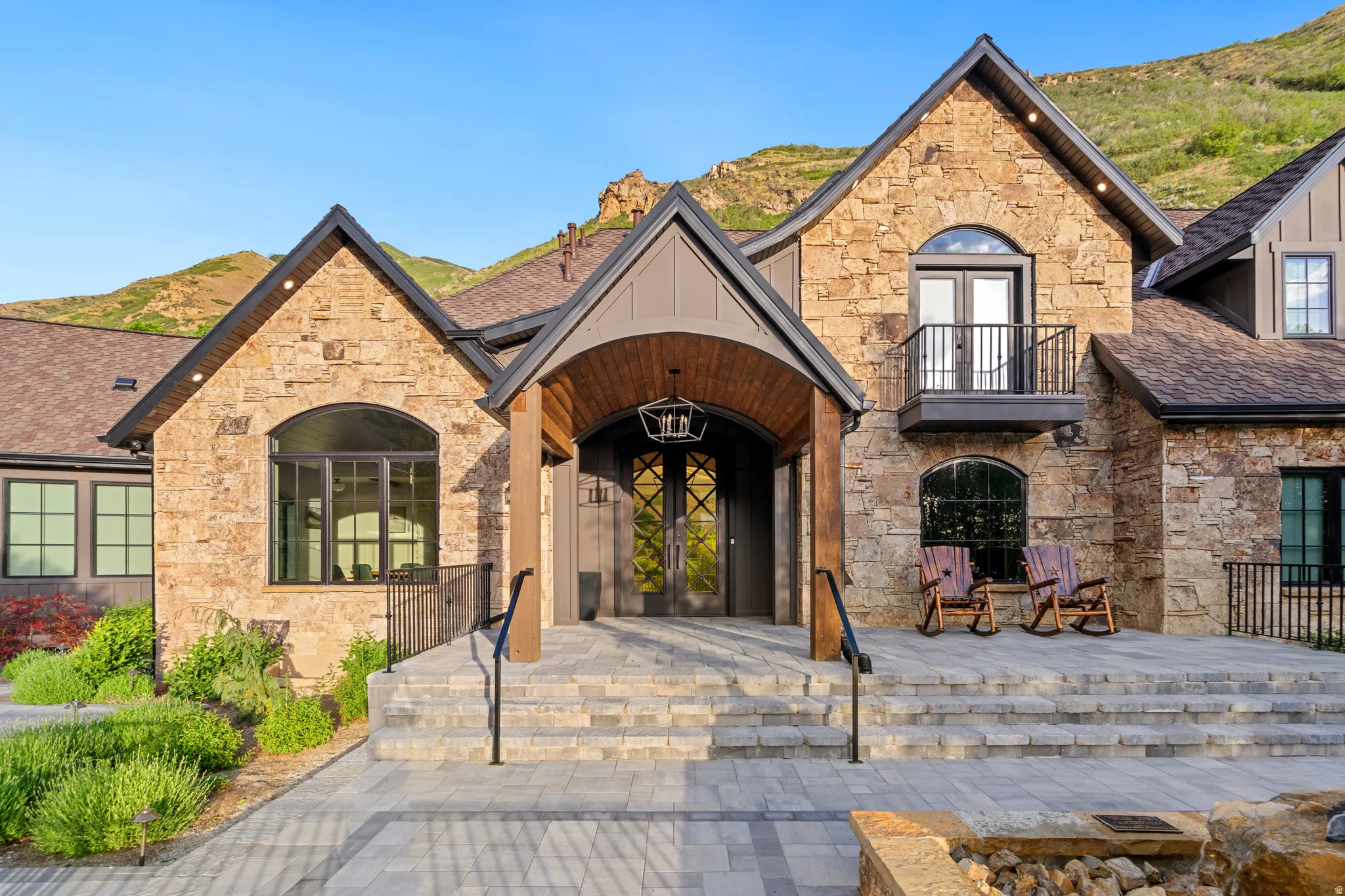 Stone and wood-clad exterior with a prominent arched entry