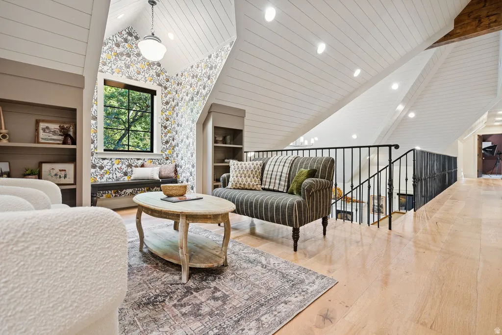 ADU.  UPSTAIRS. over GARAGE. Loft area featuring vaulted ceilings with shiplap, recessed lighting, and a prominent window
