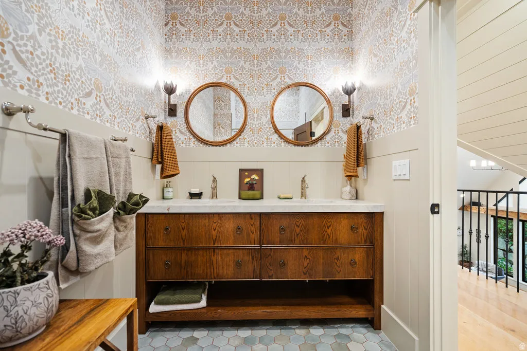 U{STAIRS Bathroom featuring a dual-sink vanity with a wood-finish cabinet and a light-toned countertop