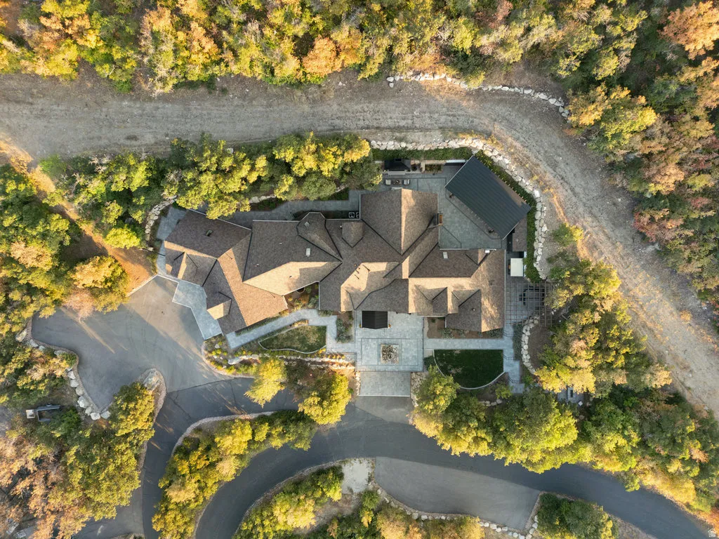 Extensive property featuring a multi-gabled roofline, stone paving, and a gravel pathway