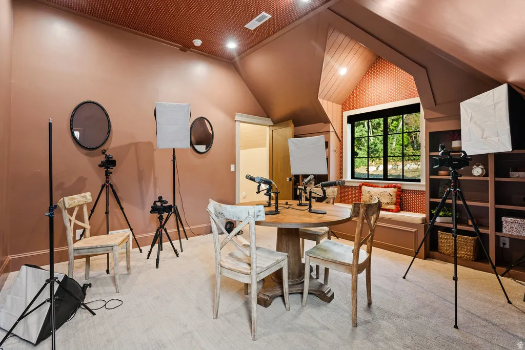 UPSTAiRS Bedroom featuring a round wood-finish table, built-in window bench, and integrated shelving