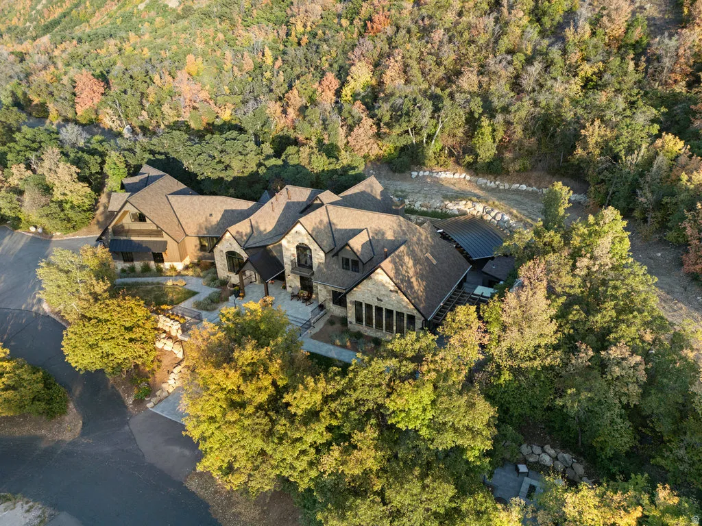 Stone and wood-sided exterior featuring multiple gables and a multi-level roofline