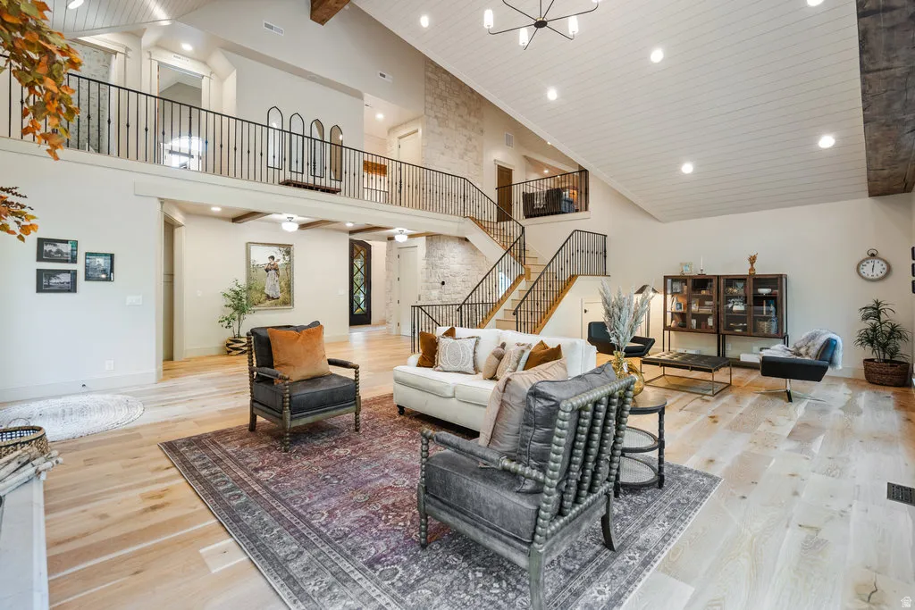 Vaulted ceilings showcasing exposed wood beams and white paneled finishes
