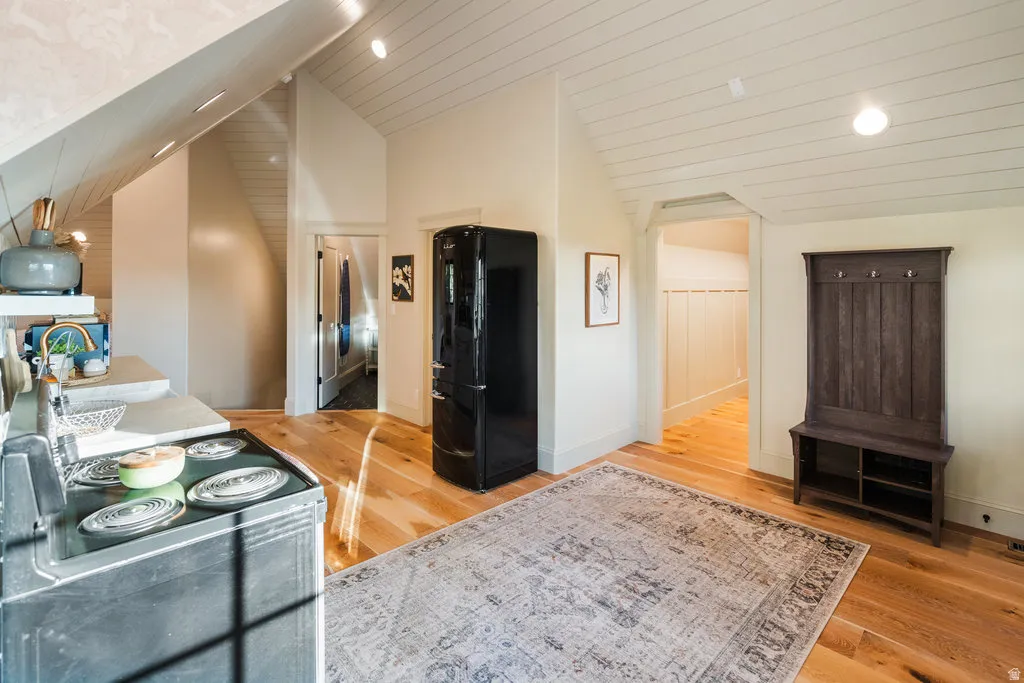 ADU Bright open-concept space featuring hardwood flooring, a vaulted planked ceiling, and recessed lighting