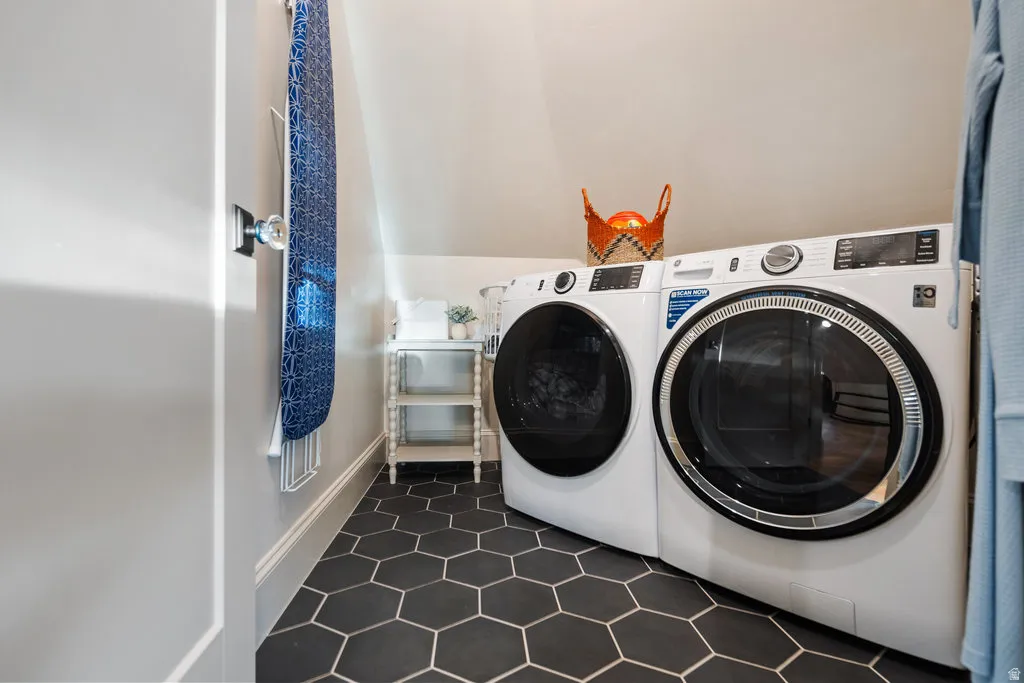 ADULaundry area featuring hexagonal floor tiling, sloped ceiling, and white baseboards