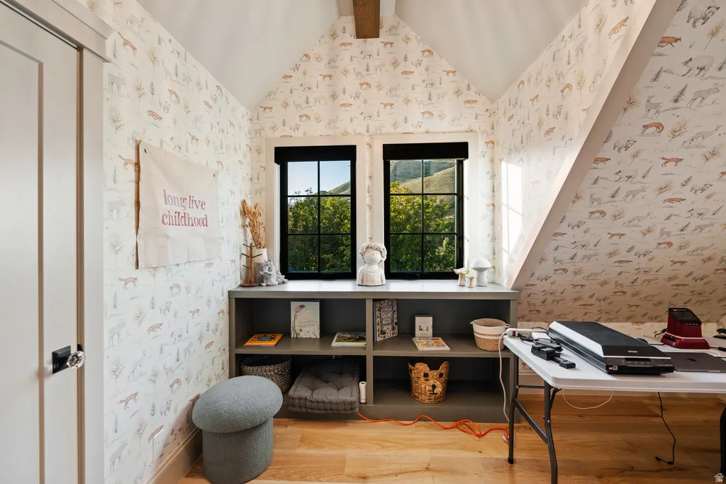Windowed alcove featuring dual pane windows with black trim, a built-in shelving unit, and patterned wall covering