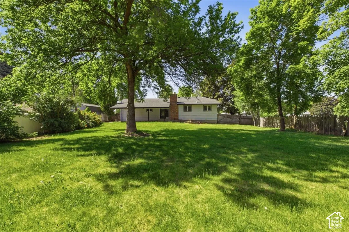Spacious backyard featuring extensive green lawn