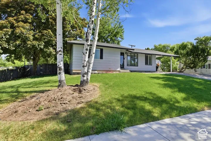 Ranch-style exterior with a covered entryway and black window trim