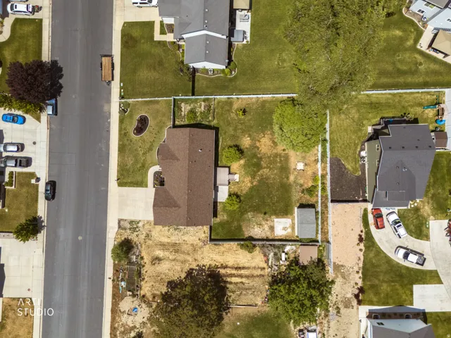 Property featuring a brown shingle roof and a paved driveway