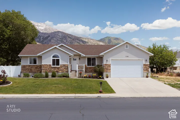 Ranch-style exterior with stone veneer accents and stucco siding