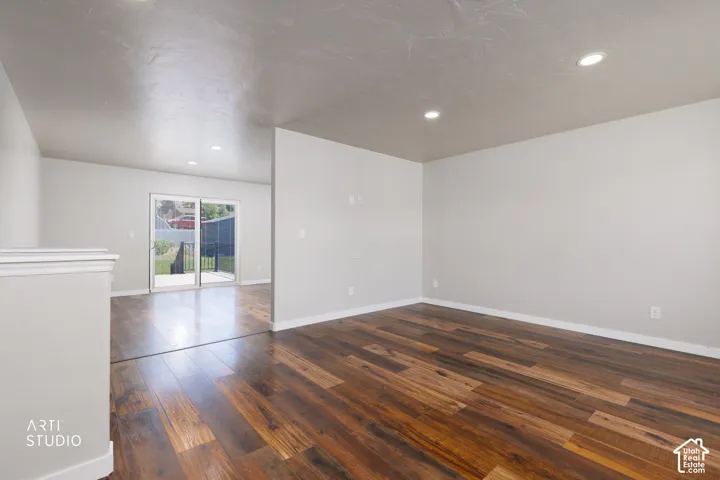 Open concept room featuring wood-finish flooring, recessed lighting, and light-toned walls
