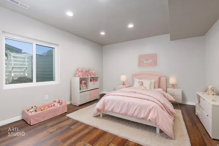 Spacious room featuring wood-finish flooring, recessed lighting, and a large window
