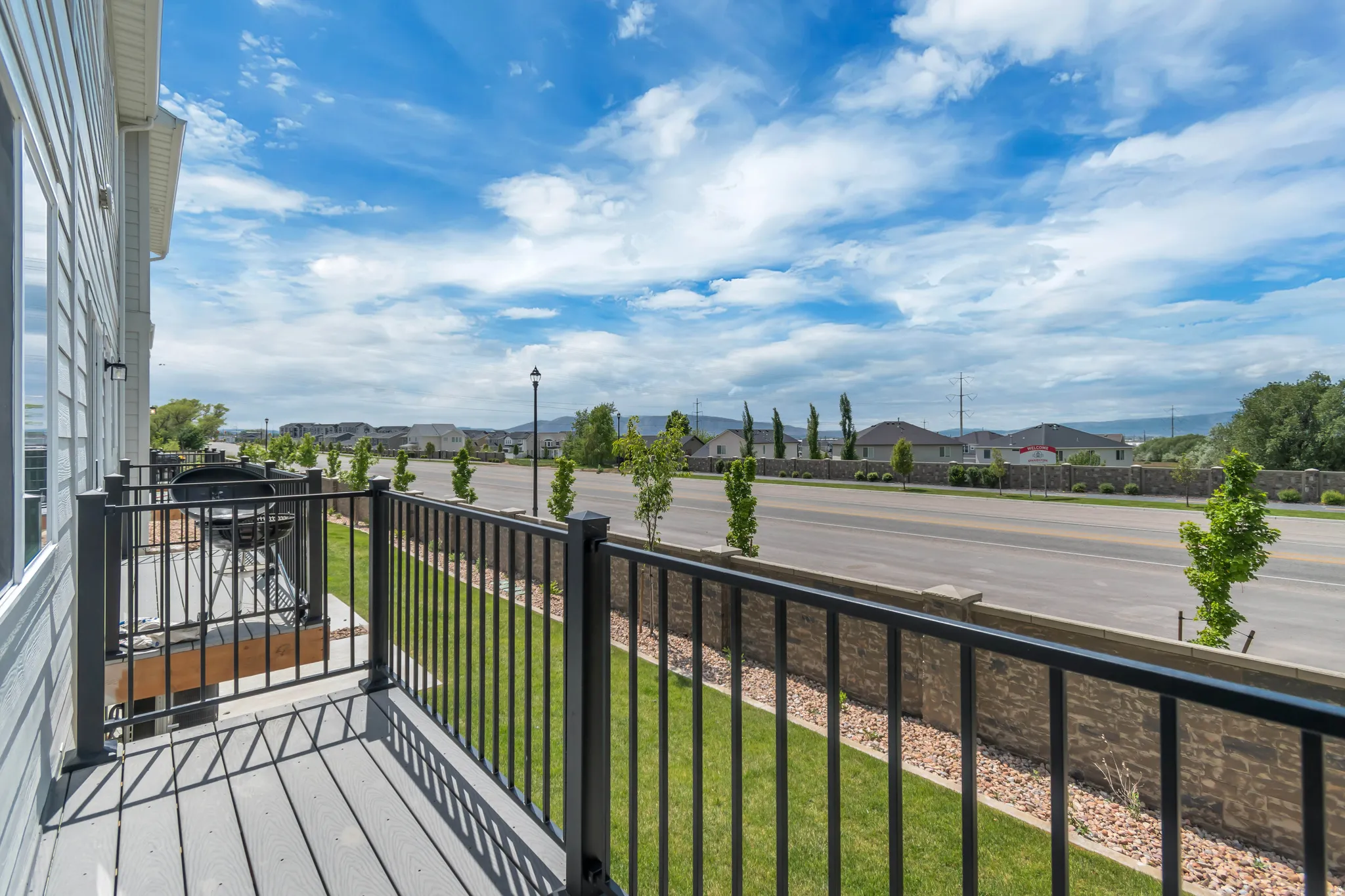 Private balcony featuring composite decking and black metal railings