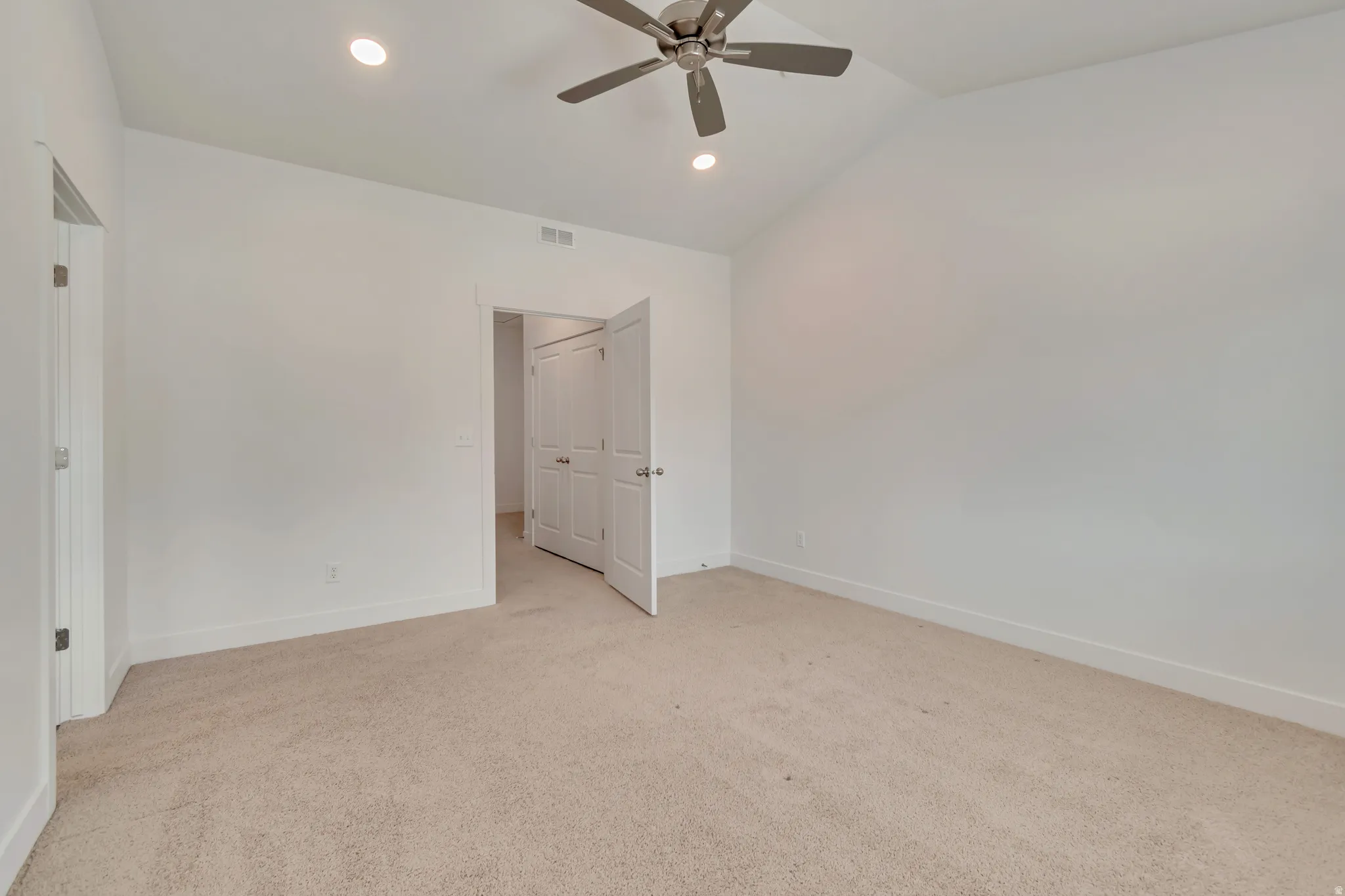 Vaulted ceiling featuring a ceiling fan with integrated lighting