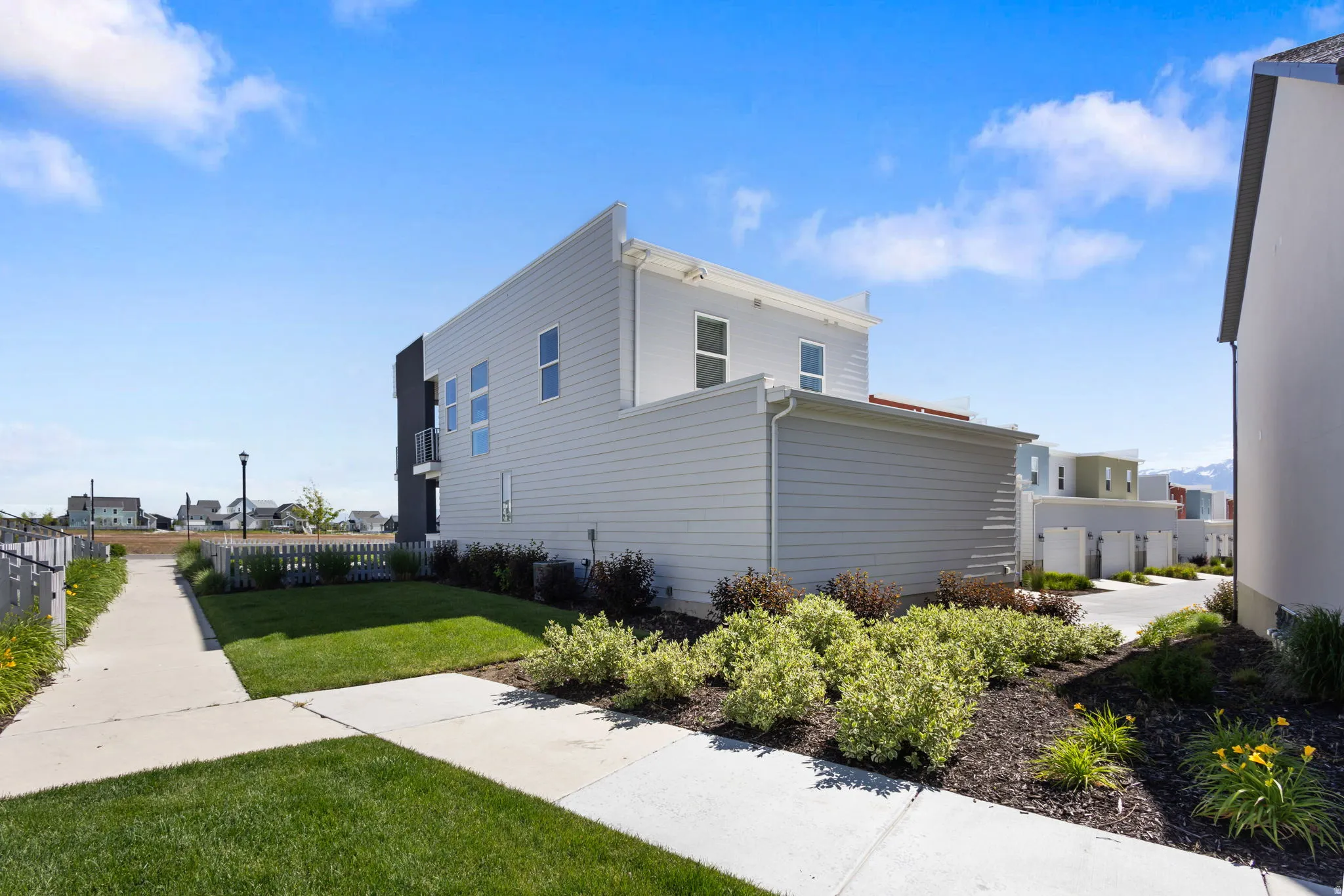 Modern exterior featuring multiple windows and a balcony