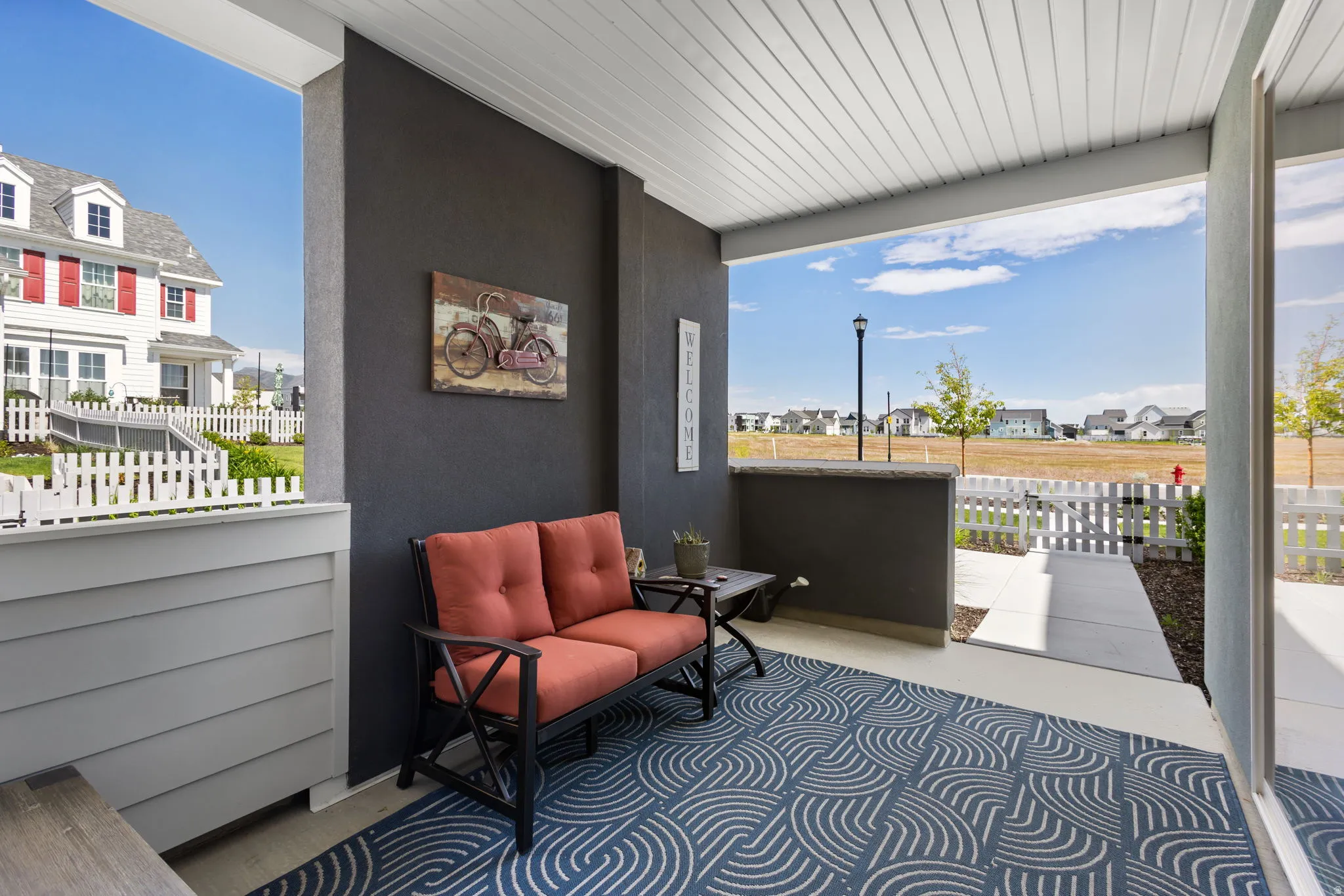 Covered patio with dark gray exterior wall and white paneled ceiling