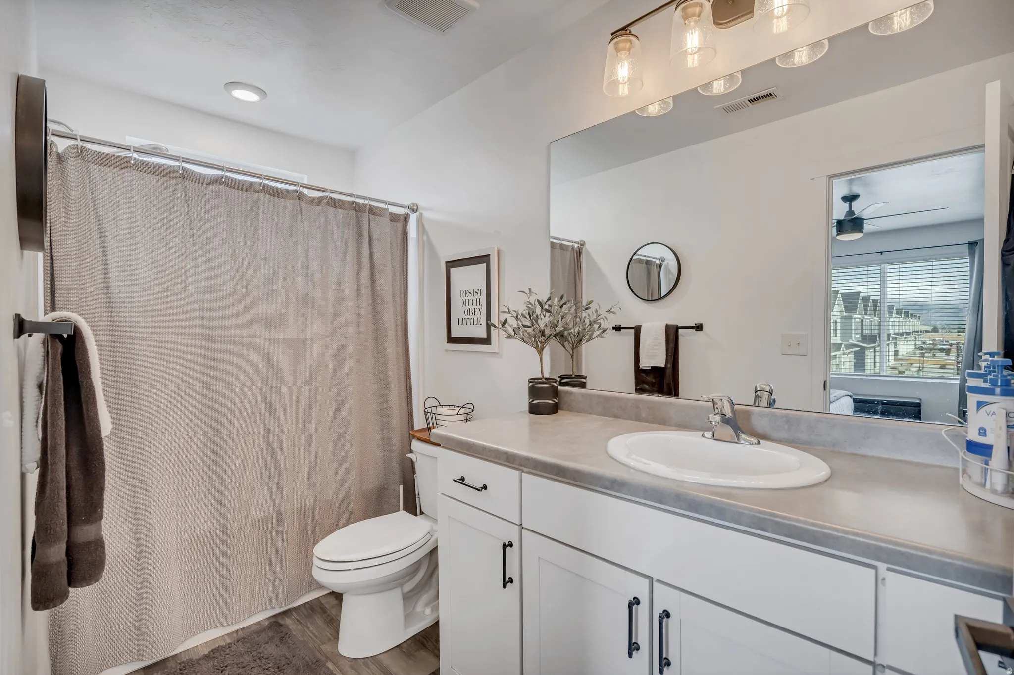 Bathroom featuring a white vanity with an undermount sink and a light gray countertop
