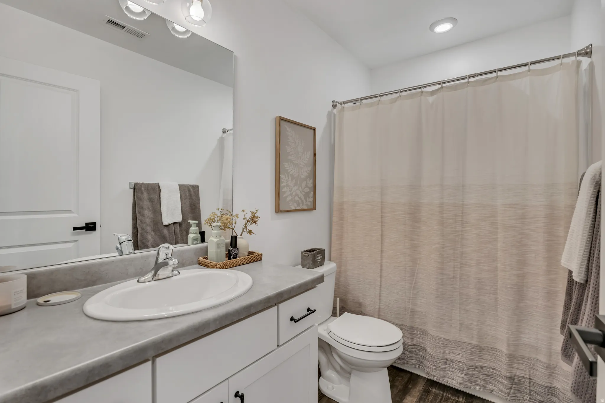 Bathroom featuring a white vanity with a light gray countertop and integrated oval sink