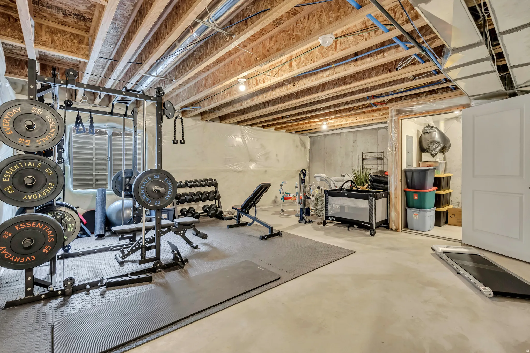 Unfinished basement space with concrete flooring