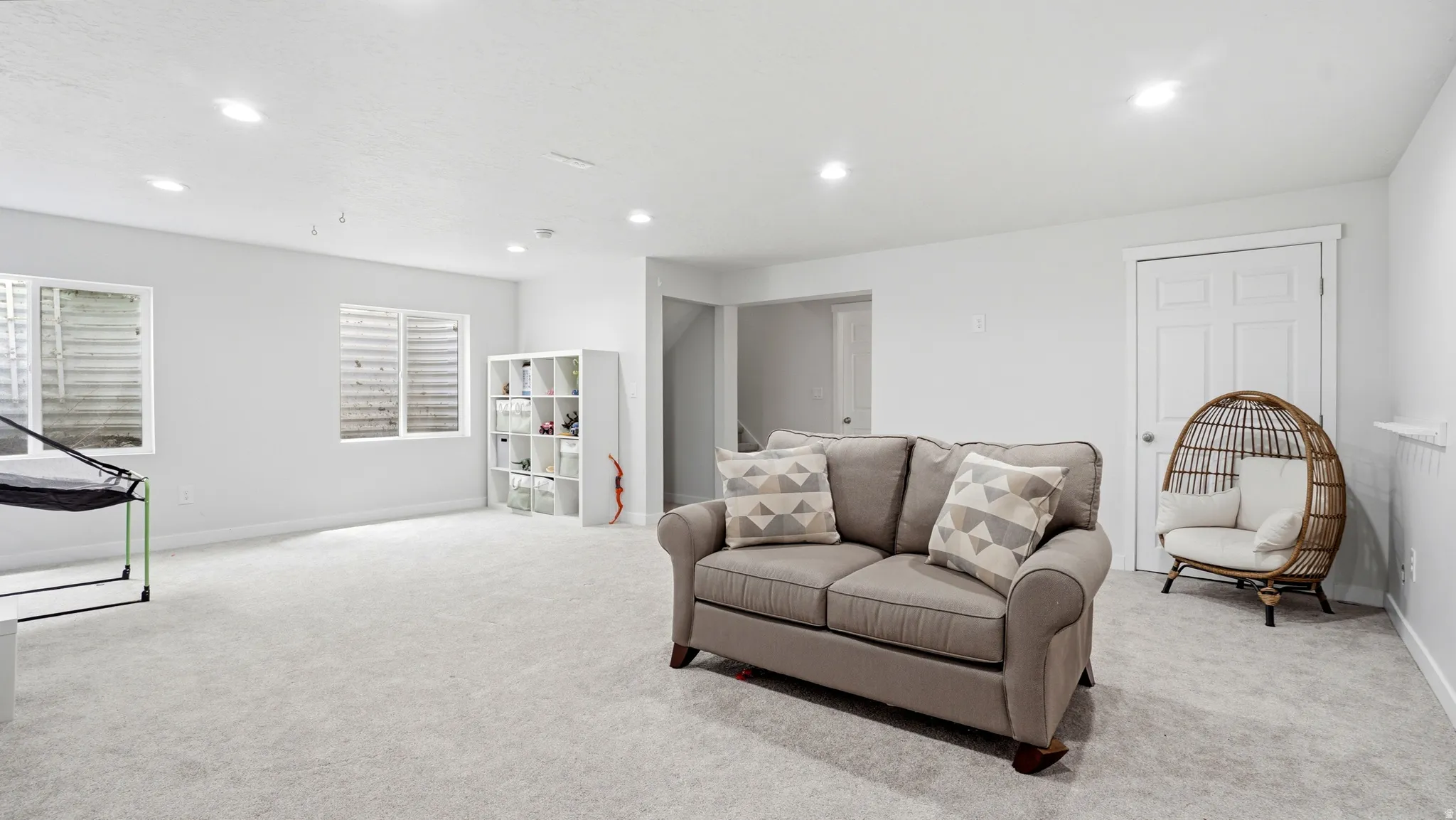 Spacious room featuring light-toned carpeting and recessed lighting