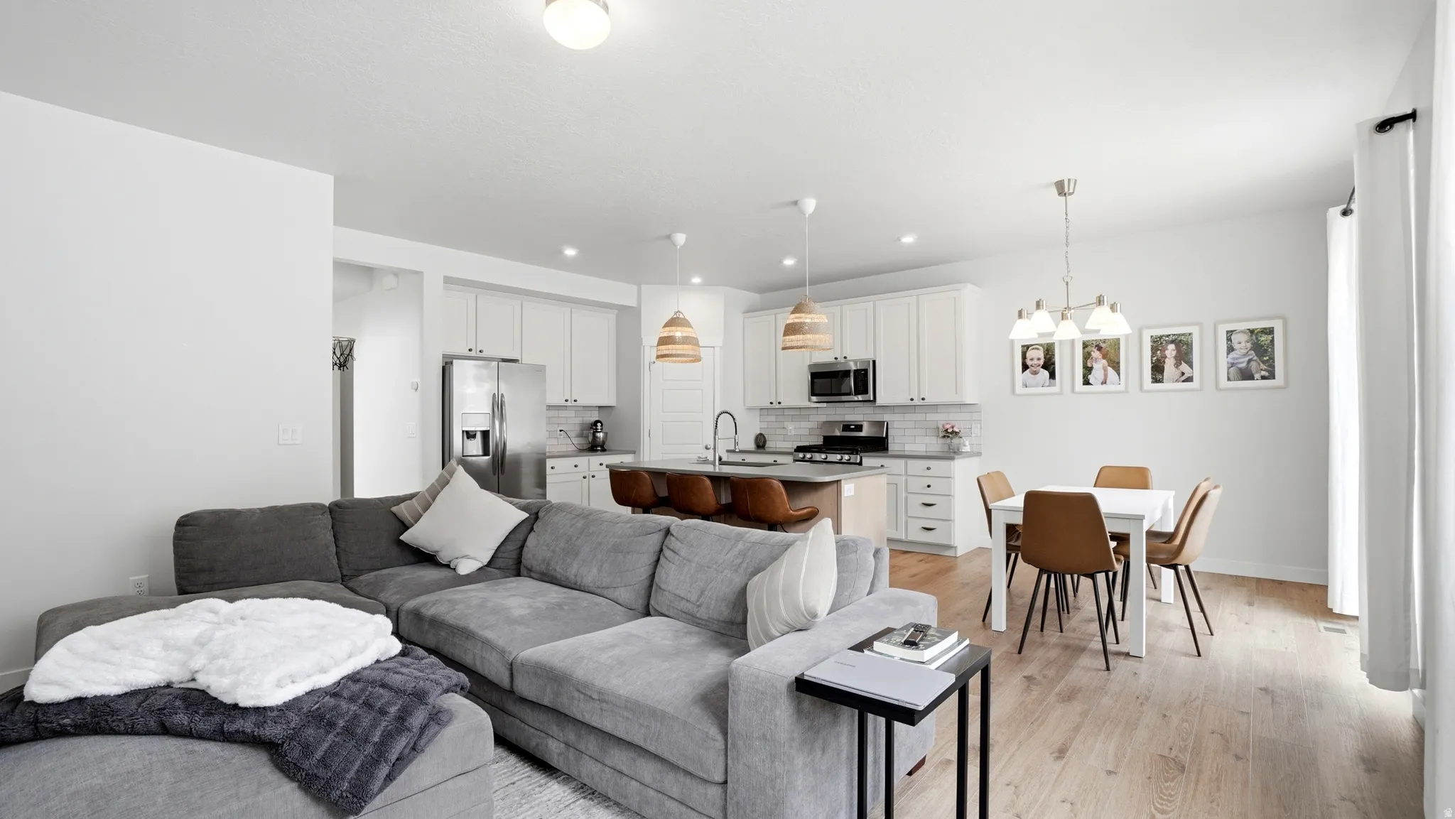 Open-concept living area featuring light wood-finish flooring throughout