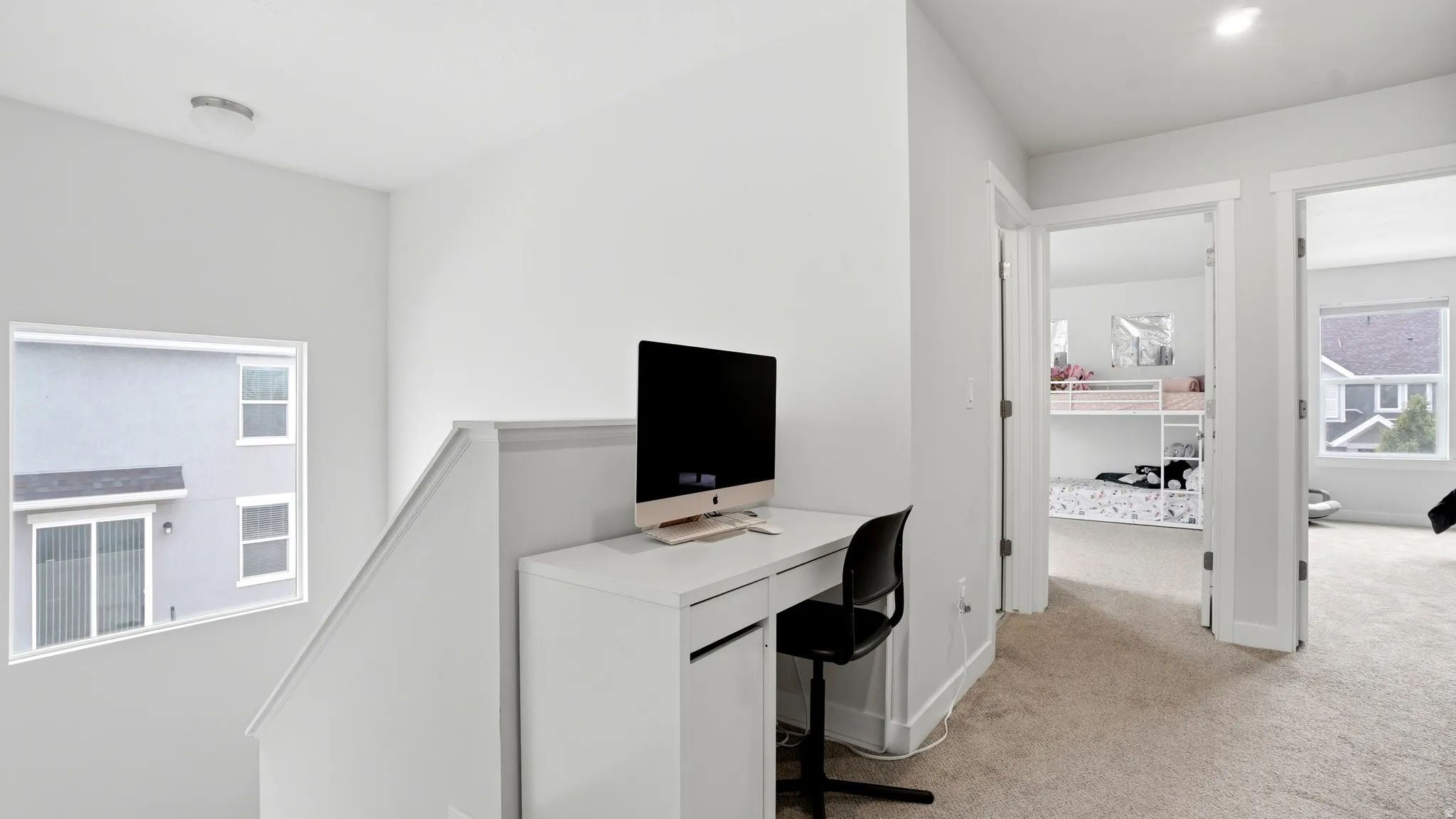 Upper-level landing featuring a built-in desk with integrated storage