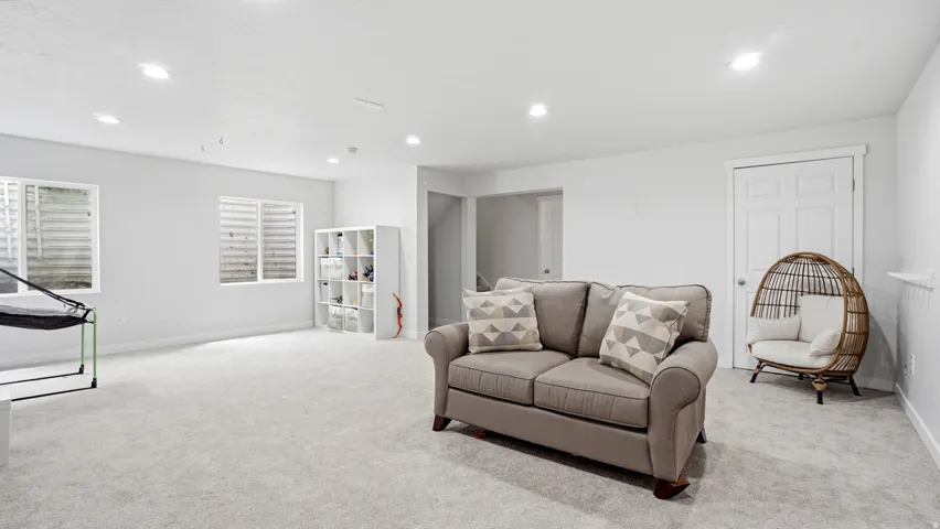 Spacious room featuring light-toned carpeting and recessed lighting