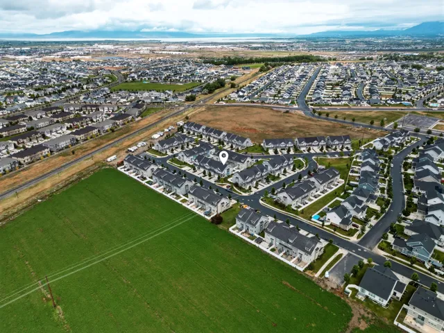 Aerial perspective showcasing a developed residential neighborhood with a variety of single-family homes and townhomes